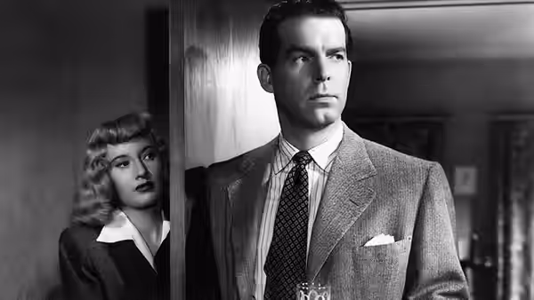 Walter Neff (Fred MacMurray) standing in a doorway with Lola Dietrichson (Jean Heather) behind him