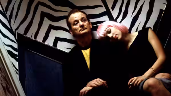 Bob Harris (Bill Murray) and Kelly (Anna Faris) leaning against a zebra-patterned wall