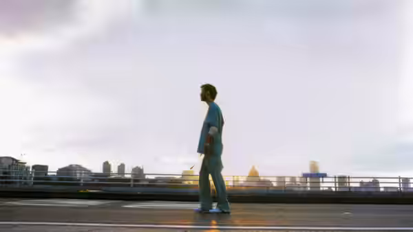 Jim (Cillian Murphy) standing on a bridge at sunrise