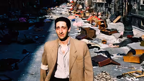 Władysław Szpilman (Adrien Brody) standing in a rubble-strewn street