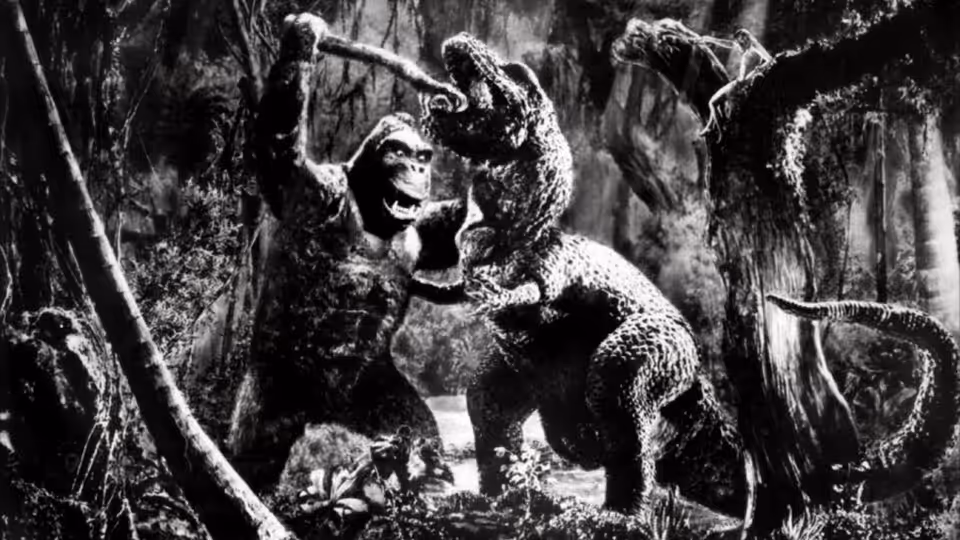 King Kong battling a dinosaur in a dense jungle