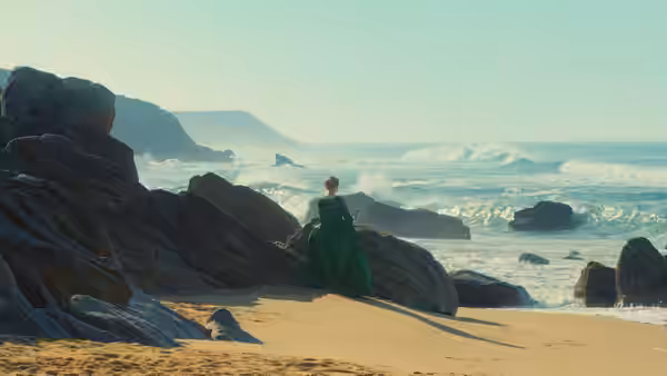 Héloïse (Adèle Haenel) in green dress stands on a rocky beach facing the sea