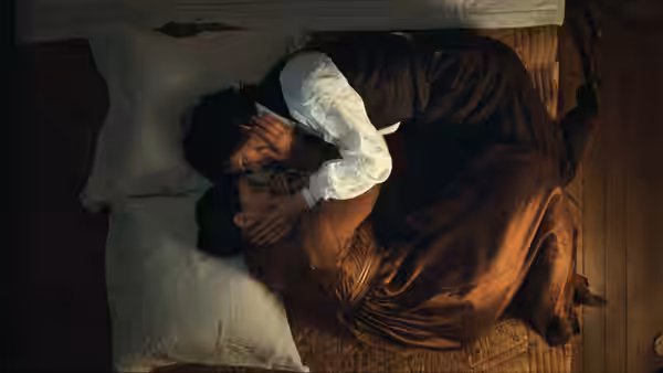 John Keats (Ben Whishaw) holds Fanny Brawne (Abbie Cornish) as they lie together in bed