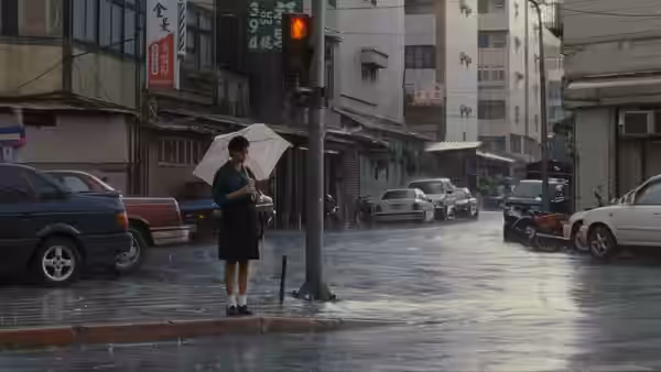 Ting-Ting stands beneath an umbrella at a rain-soaked city intersection