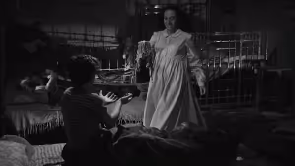 Woman in a nightgown standing in a bedroom with children in beds