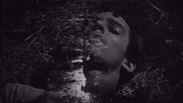 Close-up of a boy's face submerged in water with eyes closed