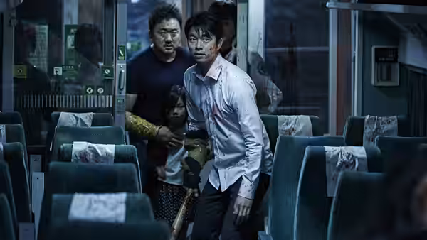 Seok-woo (Gong Yoo) leads Sang-hwa and Soo-ahn through the train