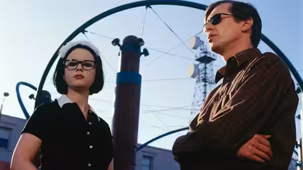 Enid (Thora Birch) and Seymour (Steve Buscemi) standing outdoors by communication towers