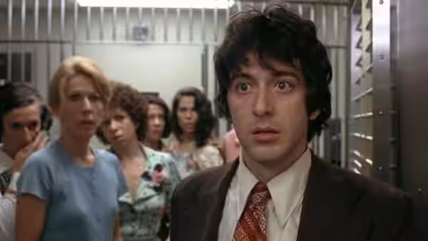 Sonny (Al Pacino) stares ahead with a concerned expression among a group