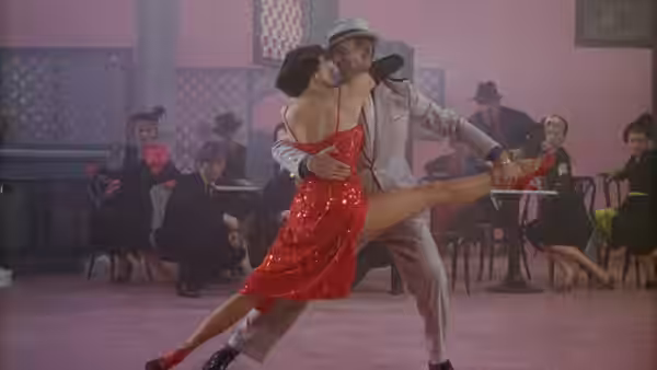 Tony Hunter and Gabrielle Gerard perform a dramatic dance as musicians watch from their chairs