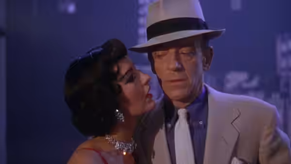 Gabrielle Gerard leans toward Tony Hunter beneath his hat during an intimate dance