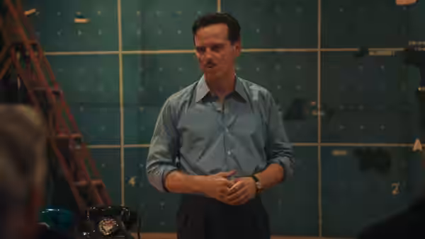 James Stagg (Andrew Scott) stands with clasped hands in map room