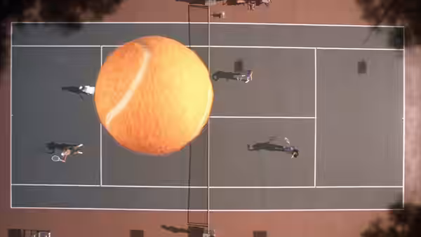 A giant orange ball hangs over four people scattered across a tennis court