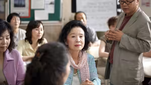 Yang Mi-ja (Yoon Jeong-hee) seated among others inside a classroom