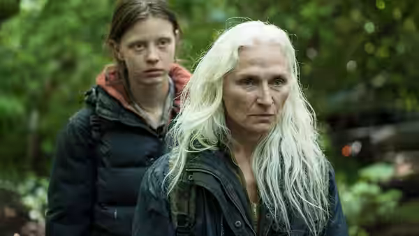 Kathryn (Olwen Fouéré) stands with Milja (Mia Goth) in the forest