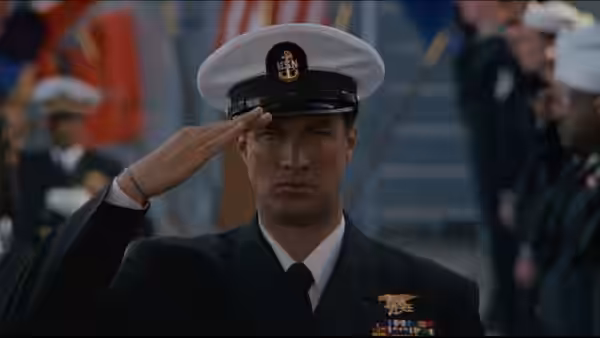 Casey Ryback (Steven Seagal) salutes in dress uniform aboard a naval ship