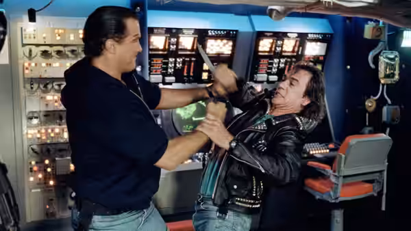 Casey Ryback (Steven Seagal) wrestles an armed man in a submarine control room