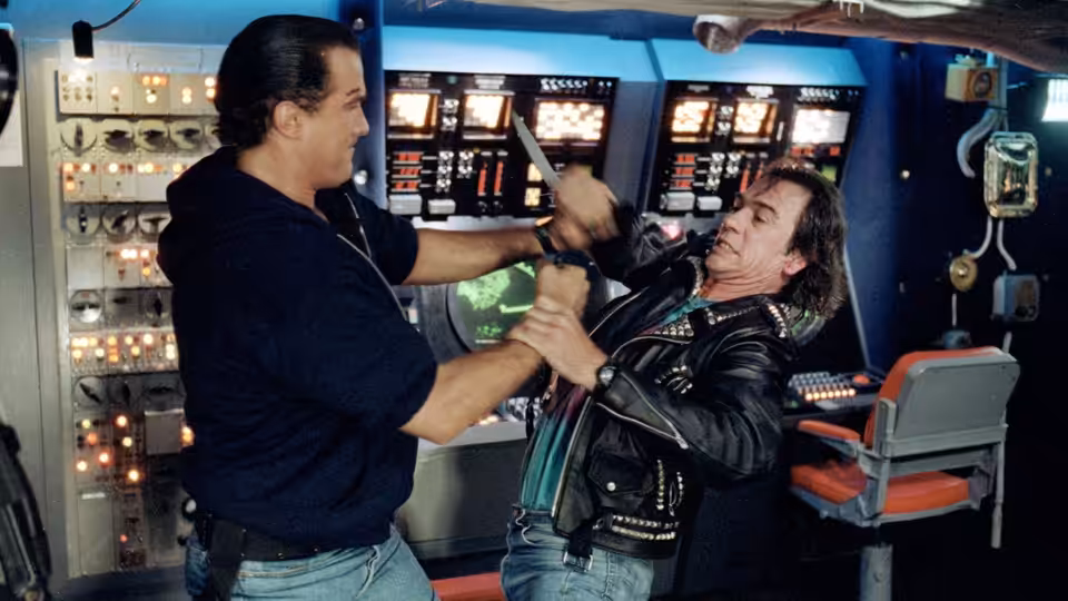 Casey Ryback (Steven Seagal) wrestles an armed man in a submarine control room