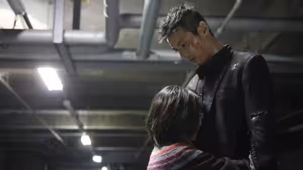 Cha Tae-sik (Won Bin) stands beside Jeong So-mi in a low-ceilinged underground room