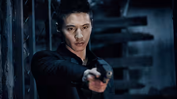A man in black aims a handgun in a dim industrial interior