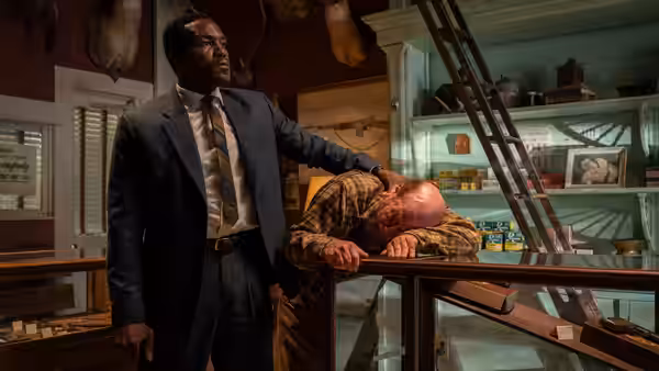 Wayne Strider (Yahya Abdul-Mateen II) stands over a man slumped on a counter
