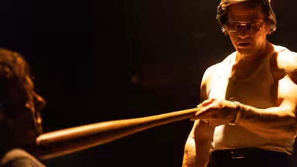Gregory Scarpa (Mark Wahlberg) grips a baseball bat facing another man