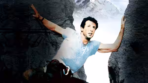 Gabe Walker (Sylvester Stallone) braced between sheer rock faces