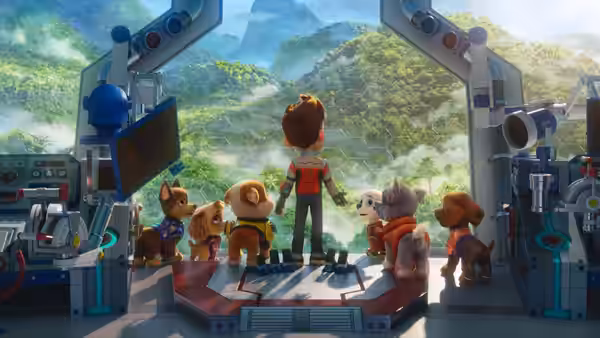A boy and dogs gather on a platform overlooking a misty valley