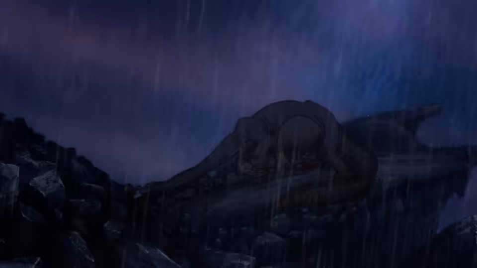 Littlefoot’s mother lies motionless among rocks as rain falls around her