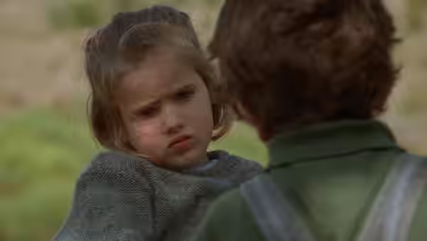 Ponette (Victoire Thivisol) looks up at a child in green outdoors