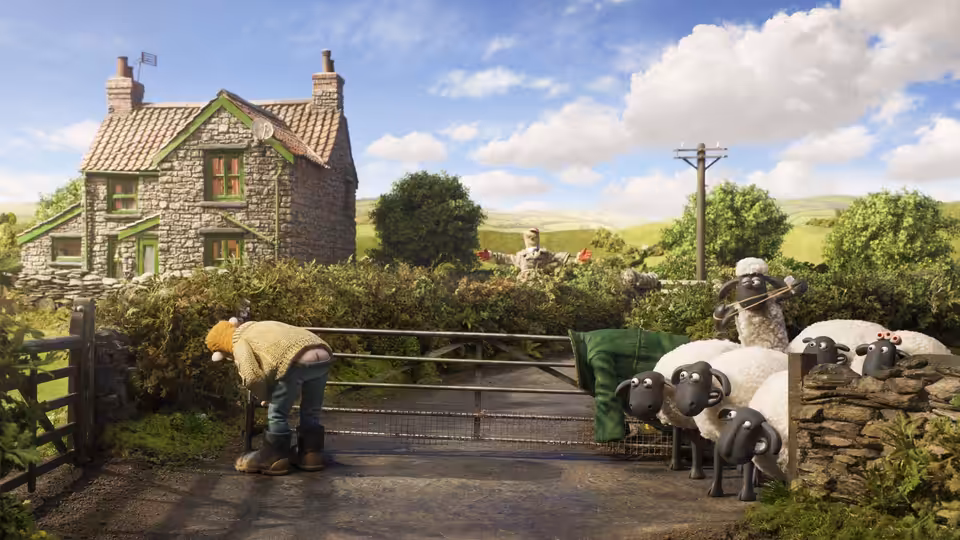 The Farmer (John Sparkes) bends over a farm gate as sheep watch from beside a stone wall