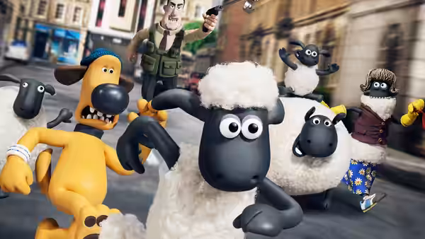 Shaun (Justin Fletcher) runs through a city street with sheep and Bitzer (John Sparkes)