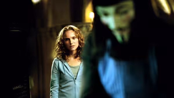 Evey (Natalie Portman) faces V in a shadowed stone hallway