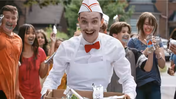 The Ice Cream Man (Ari Millen) pushes his cart among excited children