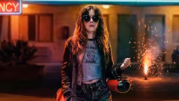 Irina Anastas holding a fire extinguisher outside a building at night