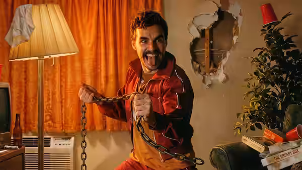 Mark chained up and shouting in a cluttered living room
