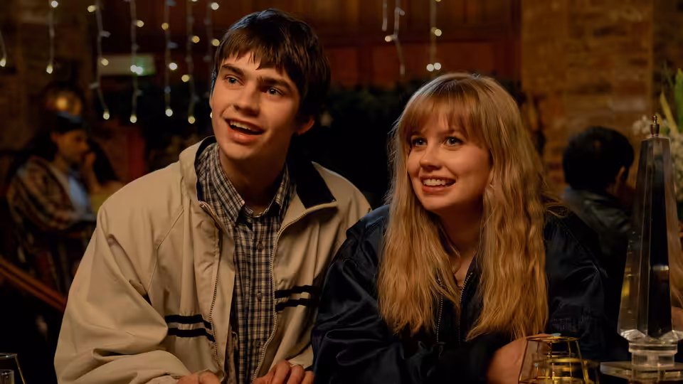 Owen (Spike Fearn) and Emily (Angourie Rice) smiling together at a restaurant table