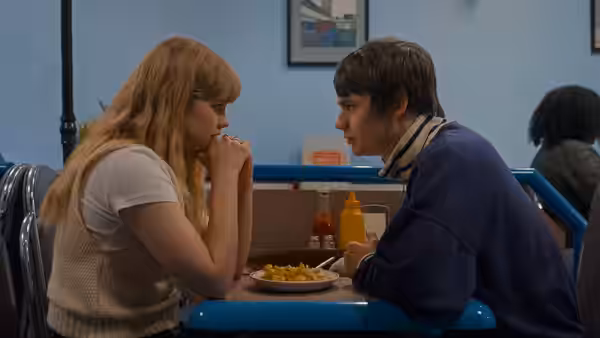 Emily (Angourie Rice) and Owen (Spike Fearn) sitting across from each other in a diner
