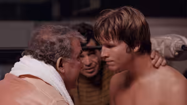 Ernie (Jeff Bridges) listens as an older man speaks to him beside the ring