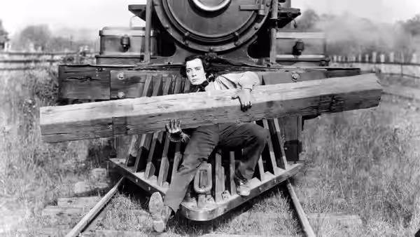 Johnnie Gray (Buster Keaton) tied under a beam on the locomotive