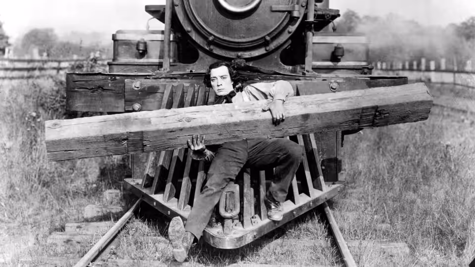 Johnnie Gray (Buster Keaton) tied under a beam on the locomotive