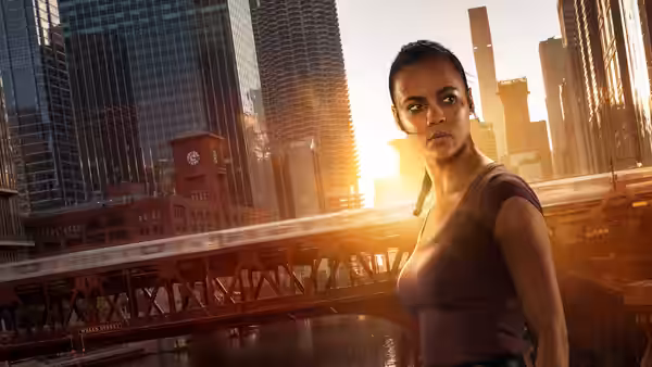 Frances Neagley (Maria Sten) standing on a bridge with city skyline behind