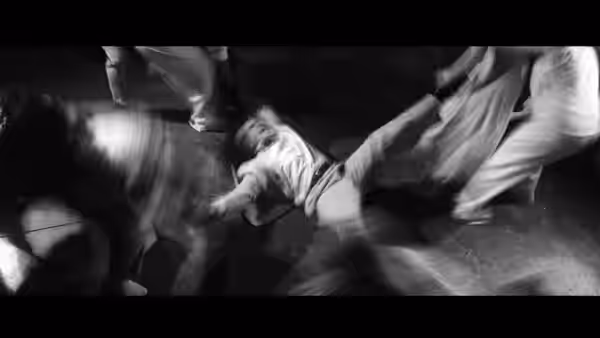 The Pianist (Jack McLaughlin) on the floor amid blurred moving dancers