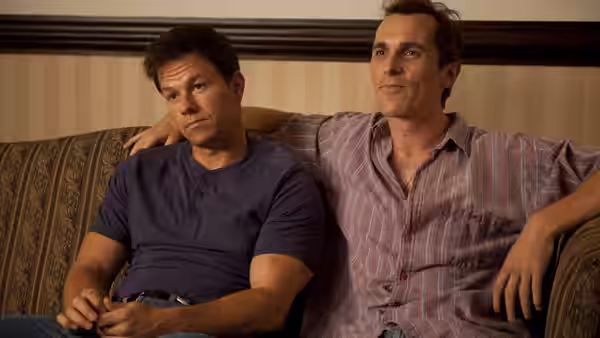 Micky Ward (Mark Wahlberg) and Dicky Eklund (Christian Bale) sit together on a couch