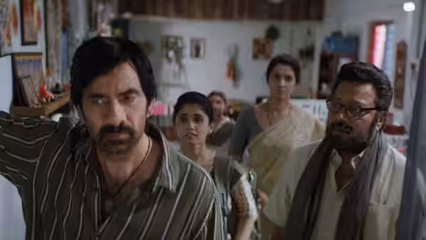 A man leads three women and another man through a crowded shop