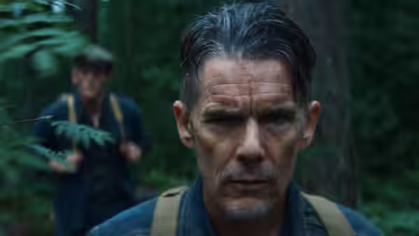 Samuel Murphy (Ethan Hawke) walking through a forest with a companion