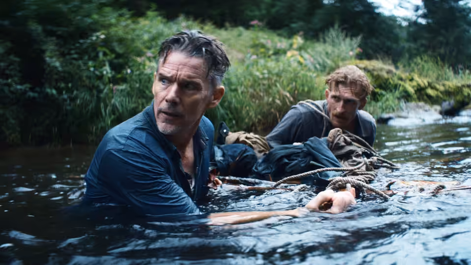 Samuel Murphy (Ethan Hawke) wading through a river with another man