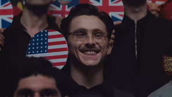 Marty Mauser (Timothée Chalamet) smiling in a crowd with an American sign
