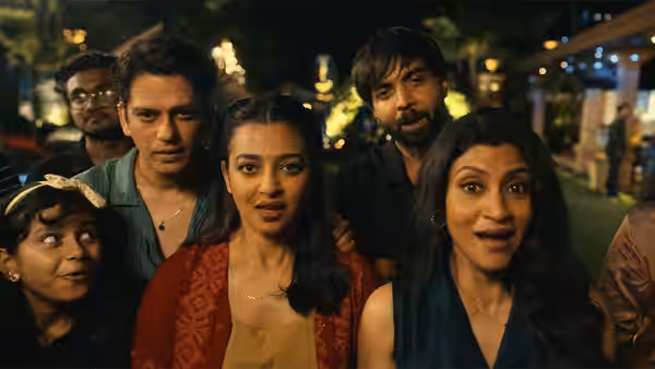 A group of men and women standing together outdoors at night
