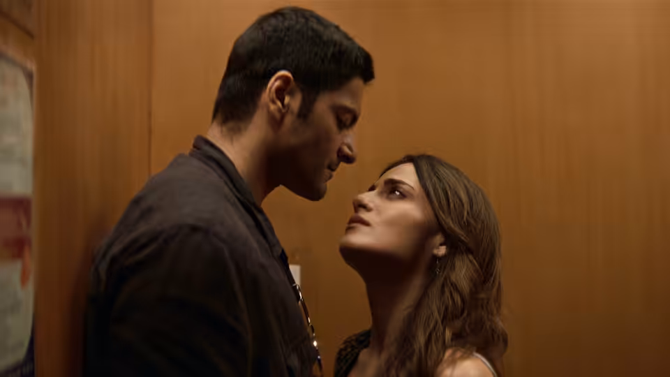 Man and woman stand close face to face in a wooden elevator